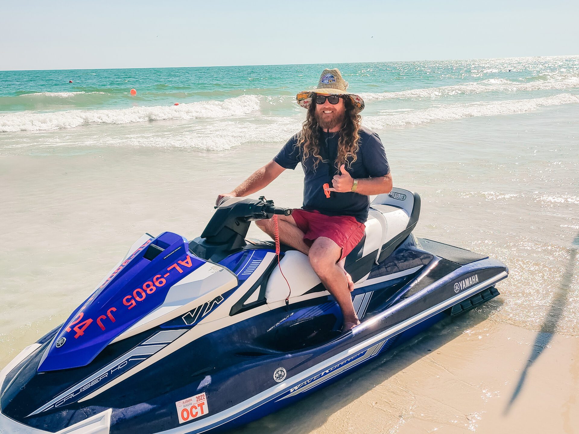 a man sitting on a jet ski on the beach