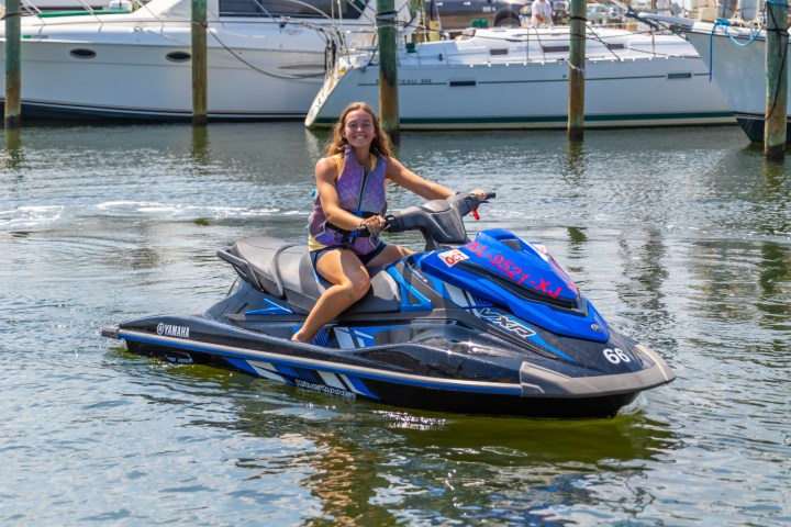 a woman sitting on a jet ski